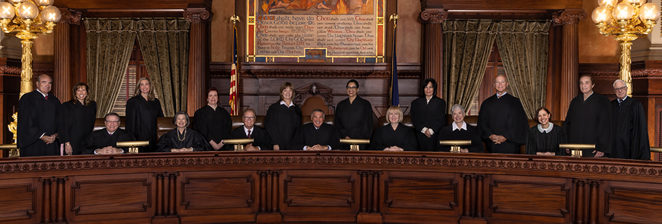 Image of the superior court members in the court hall.
